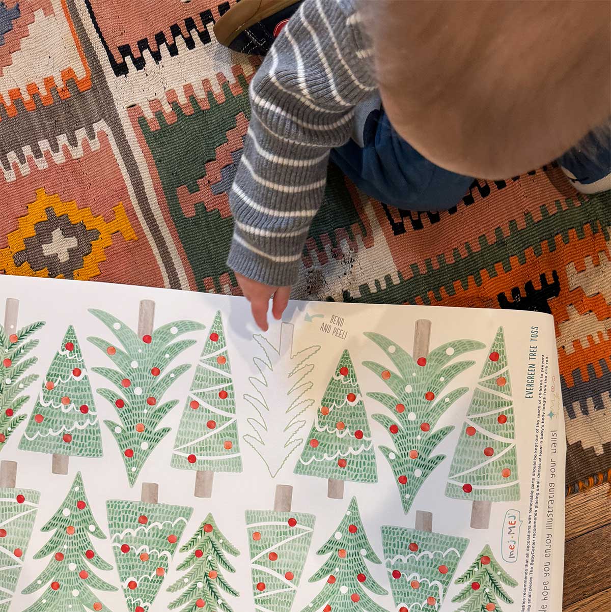 Toddler pointing to Mej Mej Christmas  wall decals.