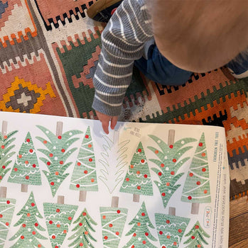 Toddler pointing to Mej Mej Christmas  wall decals.