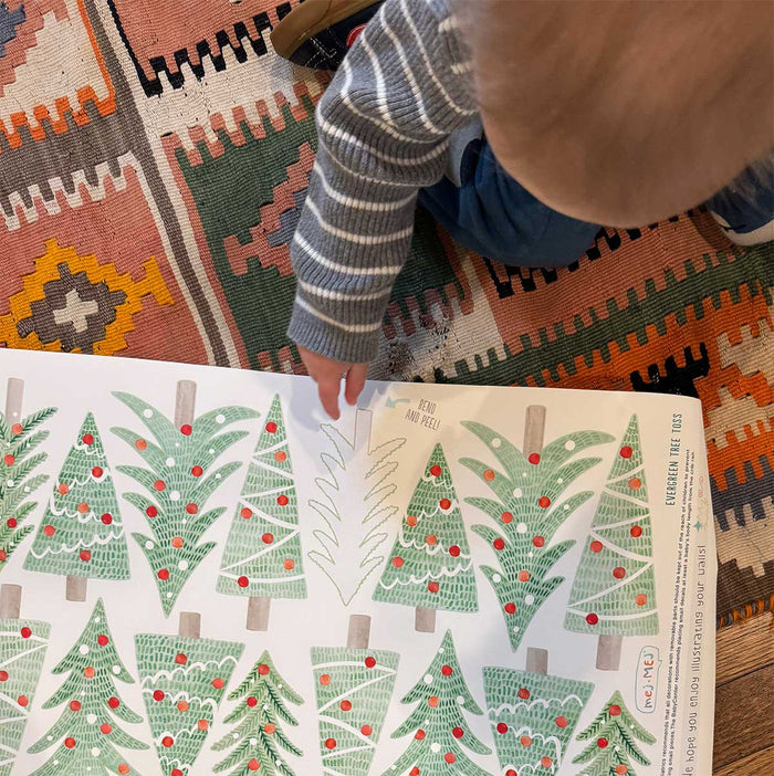 Toddler pointing to Mej Mej Christmas  wall decals.