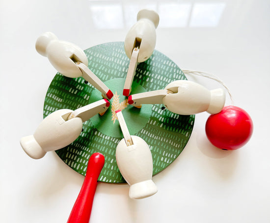 Closeup of cheerful wooden chicken paddle toy  by Mej Mej