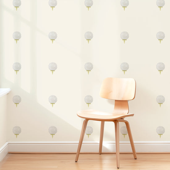 A wall is decorated with watercolor golf removable fabric wall decals by Mej Mej. They are placed in a modern grid pattern. A mid-century chair sits in front of them for scale.