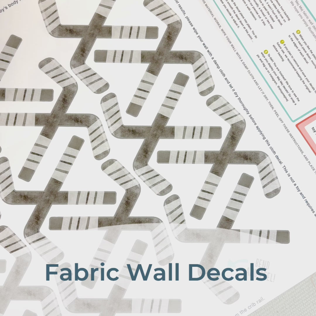 Step-by-step guide of how to install Mej Mej’s peel-and-stick removable fabric wall decals featuring watercolor hockey sticks. Perfect for sports-themed decor for hockey fans.