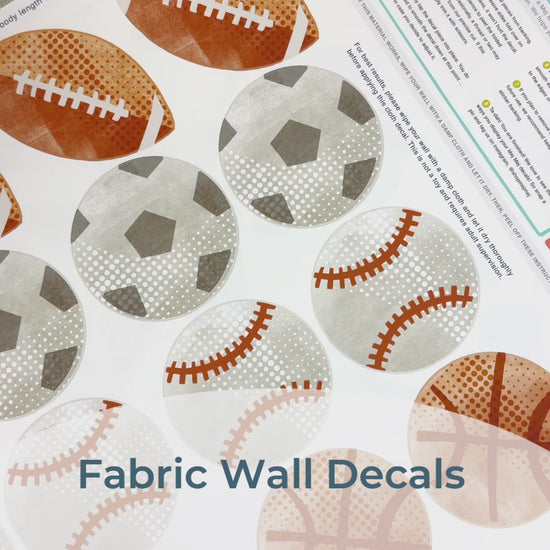 Load and play video in Gallery viewer, Step-by-step guide of how to install Mej Mej’s peel-and-stick removable fabric wall decals featuring watercolor field sports balls. Perfect for sports-themed decor for sports fans.
