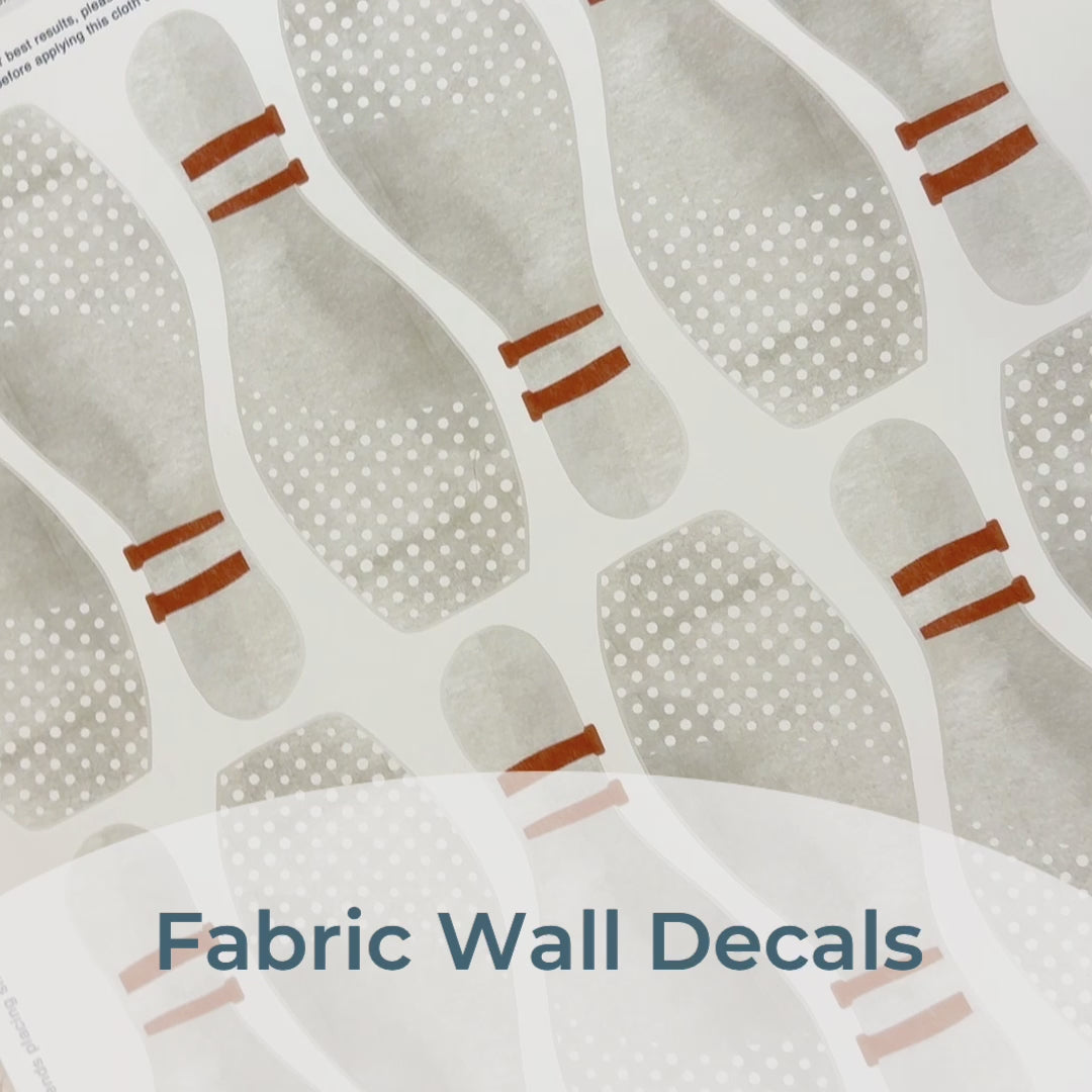 Step-by-step guide of how to install Mej Mej’s peel-and-stick removable fabric wall decals featuring watercolor bowling pins. Perfect for sports-themed decor for bowling fans.