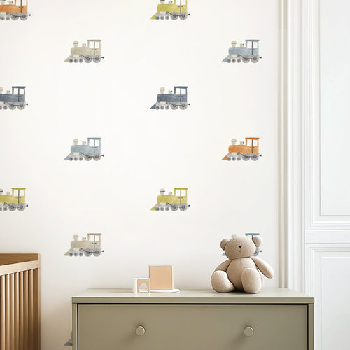 Watercolor train decals repeated in wallpaper-style grid over neutral dresser in a nursery